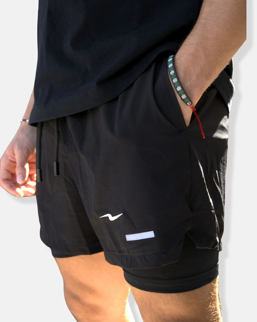 Short de running noir avec sous-short intégré et bande réfléchissante